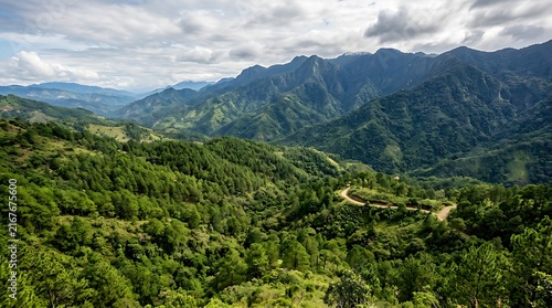 Lush green mountain peaks and dense forest under cloudy sky