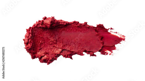 Bright red lipstick smear or makeup texture swatch isolated on a plain surface