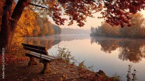 Plakat Long bench by the waters edge in a park