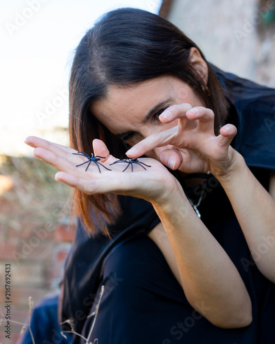 Woman Holding Toy Spiders Outdoors