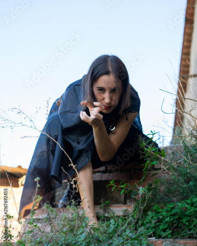 Woman Crouching and Reaching Out on Stone Steps