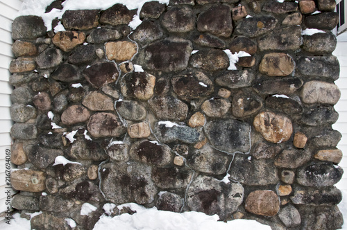 Snow covered stone chimney outdoors in rural new england