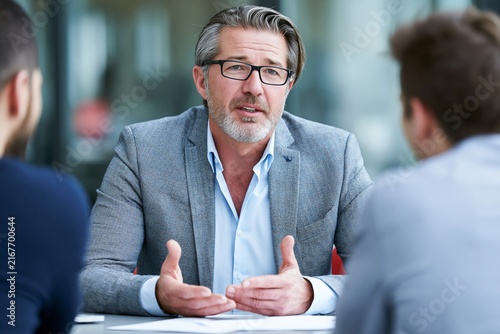 Business Executive Interviews Recent Graduate in Corporate Setting at Office