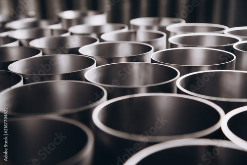 фотографія Metal Pipe Stockpile: A close-up view of a large collection of industrial metal pipes, neatly stacked and ready for use in construction or manufacturing