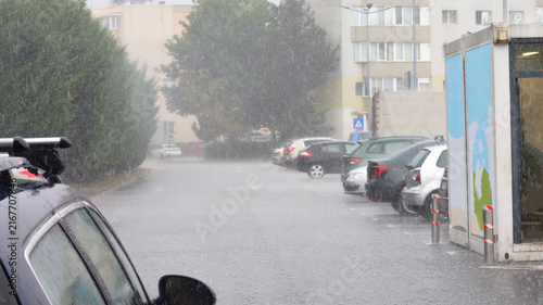 Heavy Rainstorm Downpour Over City Residential Street And Parked Cars On Wet Asphalt
