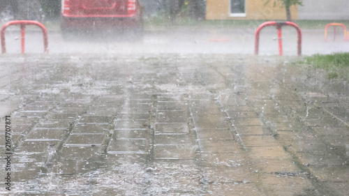 Heavy Rain Splashing On Wet Street Pavement Tiles During Storm In Residential Area