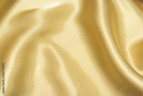 Obraz na płótnie Abstract background of soft luxurious golden fabric with elegant waves and smoot