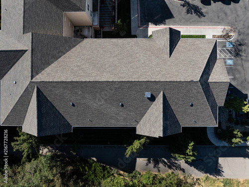 Top-down photo of residential house with angular roof design and landscaped yard
