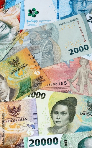 Photography Indonesian rupiah money bills in pile on table