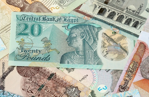 Photography Egyptian pound money bills in pile on table