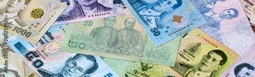 Thai baht money bills in pile on table. Thailand THB currency cash close up