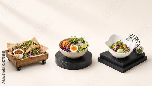 Contemporary food photography showcasing gourmet salad bowls and tacos with vibrant vegetables, modern minimalist presentation in neutral setting for culinary blog or healthy eating concept