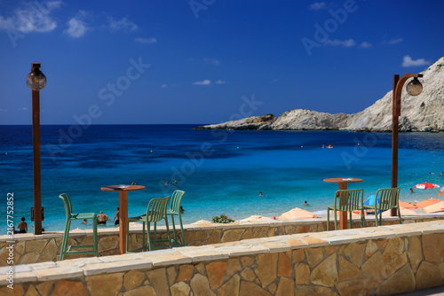 An idyllic view of the Ionian Sea from a terrace on an azure Greek beach.