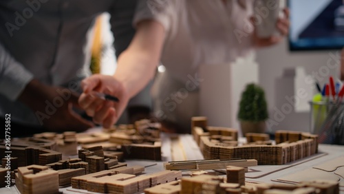 Obraz na plátně Contractors arrange a housing layout for urban site preparation, using 3D models for redevelopment, large-scale construction, infrastructure growth, city planning and real estate investment strategy