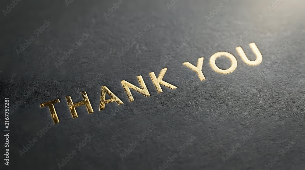 Fototapeta premium Embossed gold lettering spelling thank you on textured dark gray
