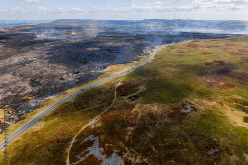 Canvas Print High angle aerial view of wildfire damage across open moorland, asphalt road act