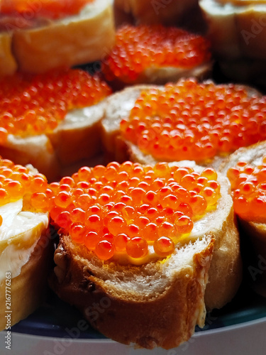 Canvas Print Bright orange caviar on toasted bread slices