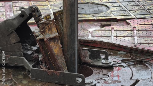 Drilling rig activity - Pull of of hole drill string with oil based mud on the rig floor. Trip out of hole.
