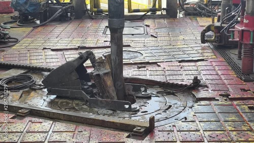 Drilling rig activity - Pull of of hole drill string with oil based mud on the rig floor. Trip out of hole.
