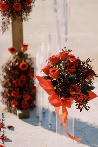 Red rose wedding floral arrangement with ribbon