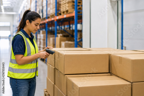 Female Warehouse Worker Scanning Cardboard Packages