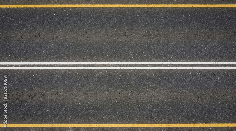 Fototapeta premium Top Down View of Asphalt Road with Double White Line and Yellow Edge Markings for Transportation Background