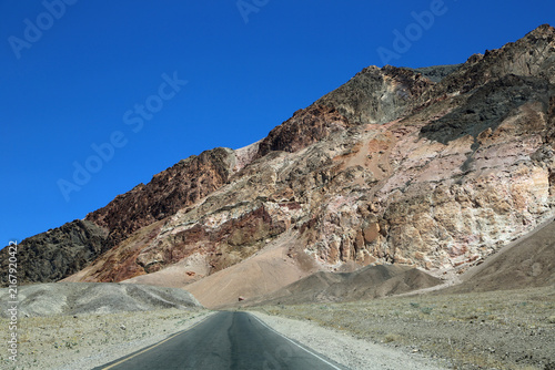 The road and pink cliffs - Death Valley National Park, California