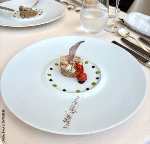 Cuadro en lienzo Gourmet appetizer with conger eel, eggplant and tomato served on white plate in