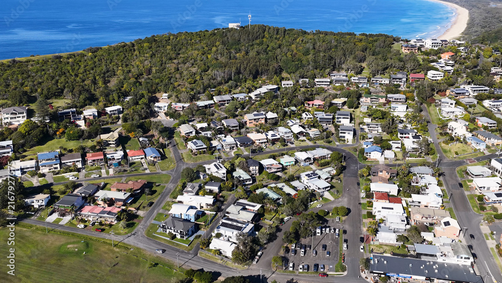 Fototapeta premium Aerial View of Suburban Houses and Green Hills in Crescent Head