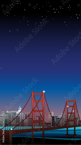 Red Suspension Bridge Over Water with City Skyline at Night