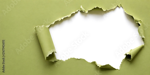 Torn green paper revealing white background with ripped edges background cardboard creative abstract material isolated