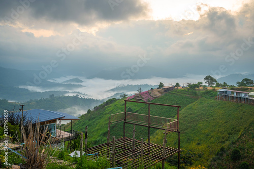 Fotografie Breathtaking sea of fog over green mountains in the morning at Mon Mork Tawan, Phop Phra, Tak, Thailand