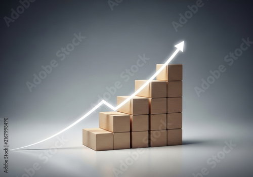 Glowing white neon arrow climbing wooden block staircase on grey background symbolizes continuous business growth and success.