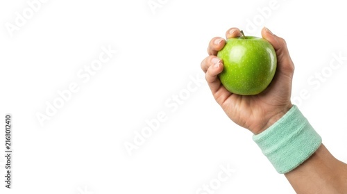 A fit person wearing a soft mint green wristband holding a fresh crisp green apple representing healthy lifestyle and fitness nutrition choices