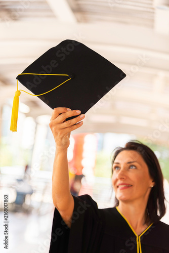 Happy young woman with diploma on graduation day