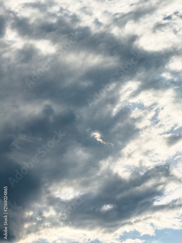 Canvas Print Clouds cover the sky with varying shades of gray and white during the afternoon