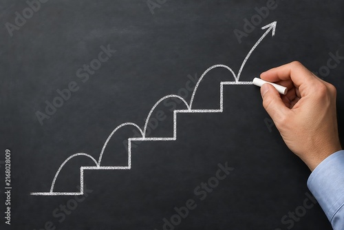 Hand drawing upward growth arrow chart on blackboard with chalk
