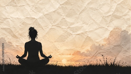 Woman meditating in lotus pose on grassy horizon at sunrise