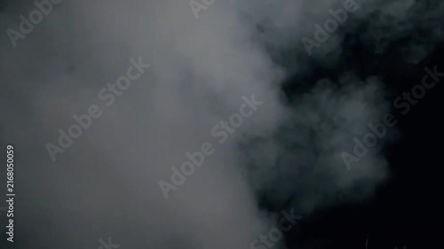 White smoke or fog rolling on a black background loop