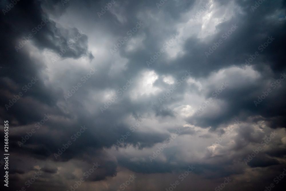 Obraz premium Dark and Moody Thunderstorm Clouds Forming in the Sky Before Heavy Rainfall and Severe Weather, Dark sky with stormy clouds,Dark clouds before a thunder-storm,clouds before rain