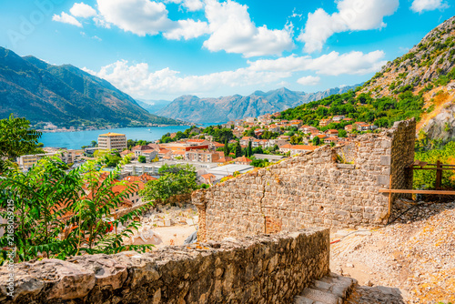 Charming narrow street in the historic old town of Kotor,  ancient stone walls, shutters, and polished limestone pavement, UNESCO site in Montenegro