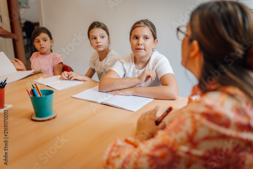 Photography Teacher explaining lesson to attentive young students