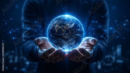 Global network technology concept featuring digital earth globe held in human hands with blue nodes