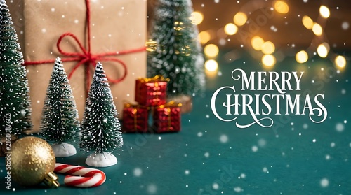 Merry christmas greeting card with miniature trees and gifts
