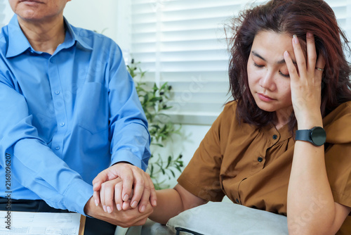 Fotografía Asian therapist providing emotional comfort holding hand sad female patient duri