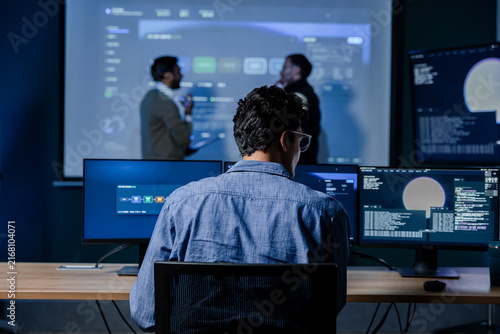 AI Engineer Monitoring Machine Learning System Performance, Reviewing Model Metrics Across Multiple Screens. Software Developer Working at Multi Monitor and Analyzing Artificial Intelligence System.