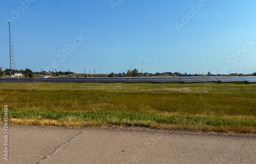 Solar farm with communication tower on Saskatchewan prairie flatland