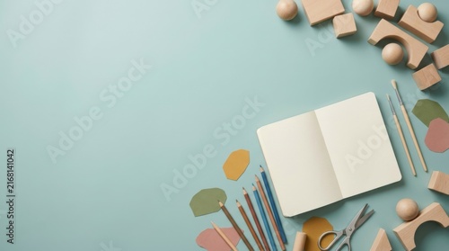 Open Notebook and Colorful School Supplies Border on Pastel Blue Background