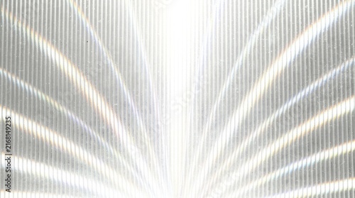 Abstract pattern of light rays radiating outward on a textured, translucent surface creating a shimmering effect.