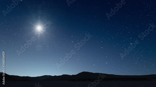 Glowing Christmas star above a peaceful mountain landscape with night sky